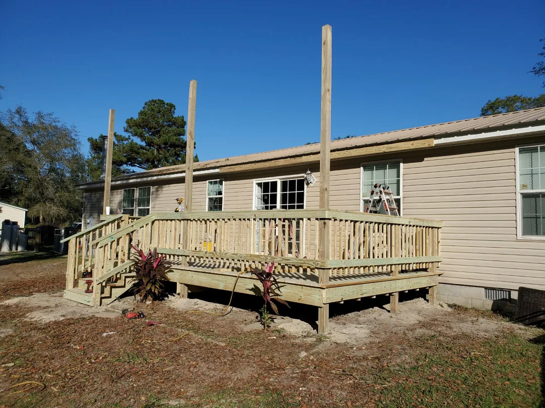 A new wood deck under construction on a manufactured home