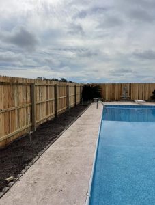 A swimming pool lined with fencing in Lake City FL. 