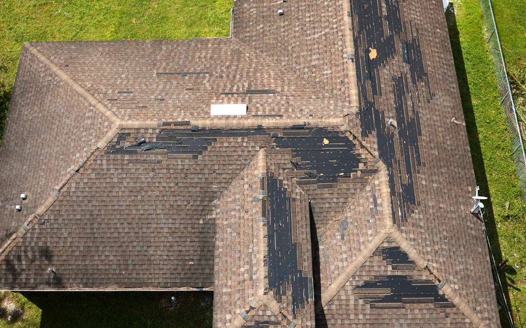 An asphalt shingle roofing showing signs its roof needs replacement in Lake City, FL.