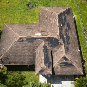 An asphalt shingle roofing showing signs its roof needs replacement in Lake City, FL.