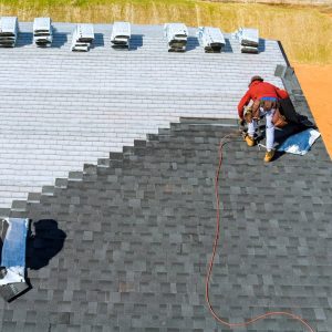 Roofing Starke FL - An image of a roofer putting on an asphalt shingle roof on a home.